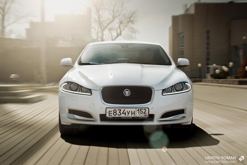 white jaguar driving on street