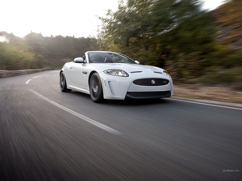 White Jaguar F-Type driving on road