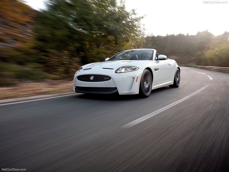 White Jaguar F-Type driving on road