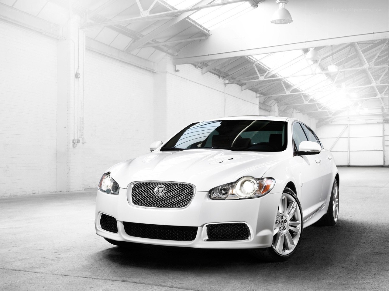 White Jaguar sedan in warehouse