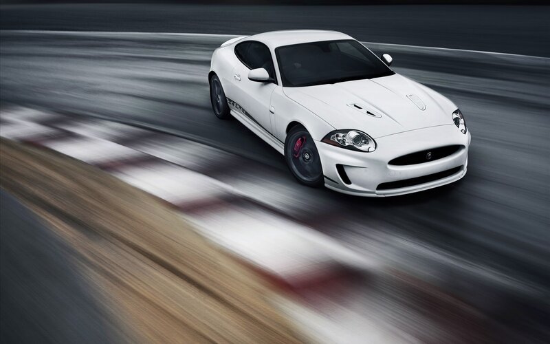 white jaguar speeding on track