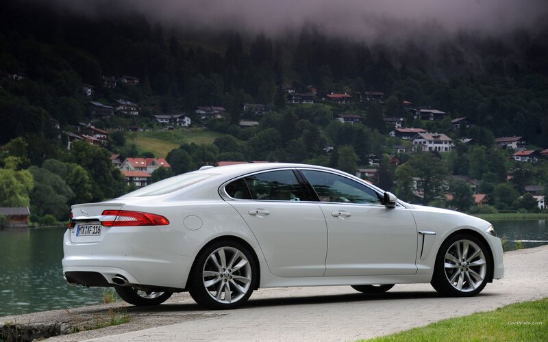 White Jaguar XF by a lake