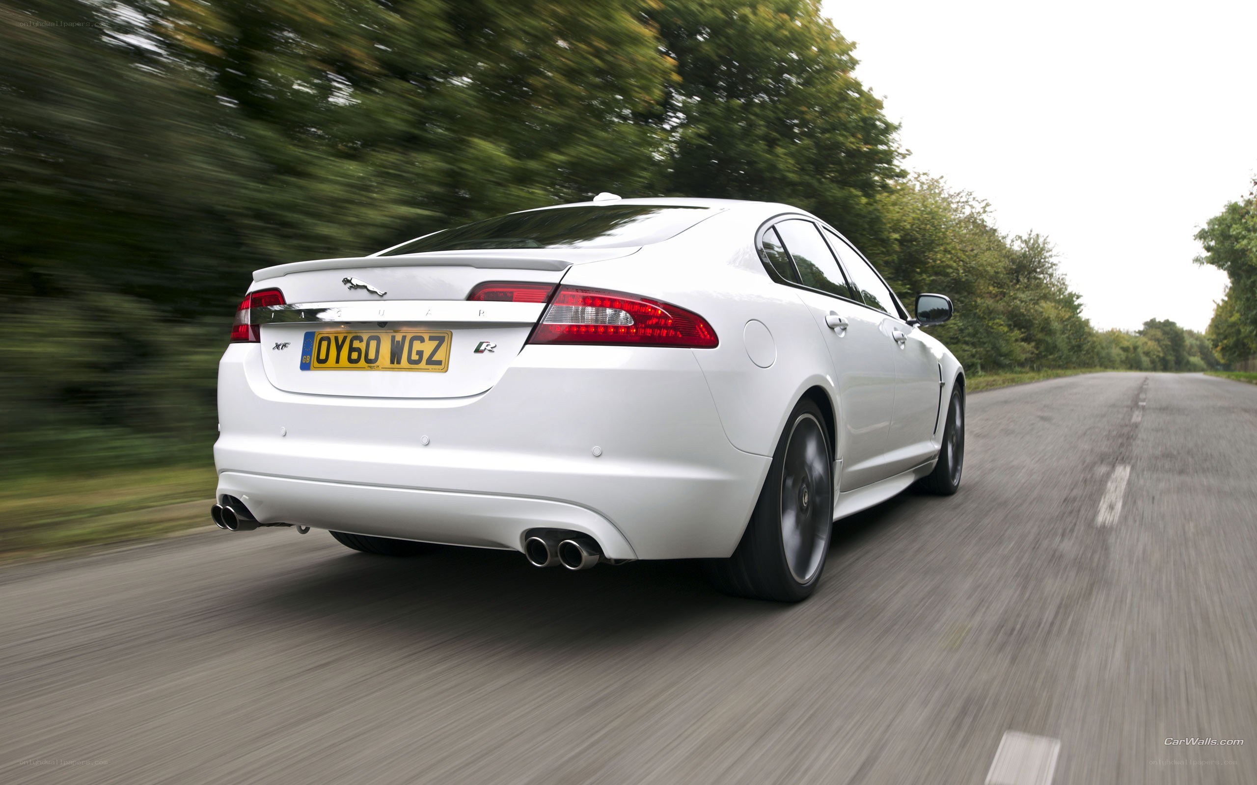white jaguar xf driving