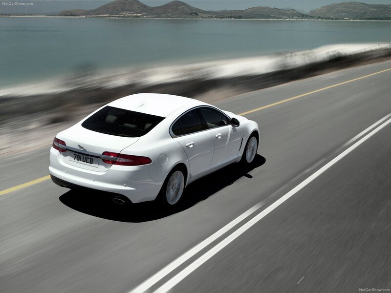 White Jaguar XF on coastal road