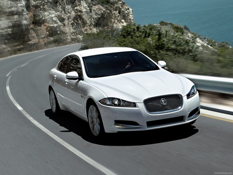 White Jaguar XF on coastal road
