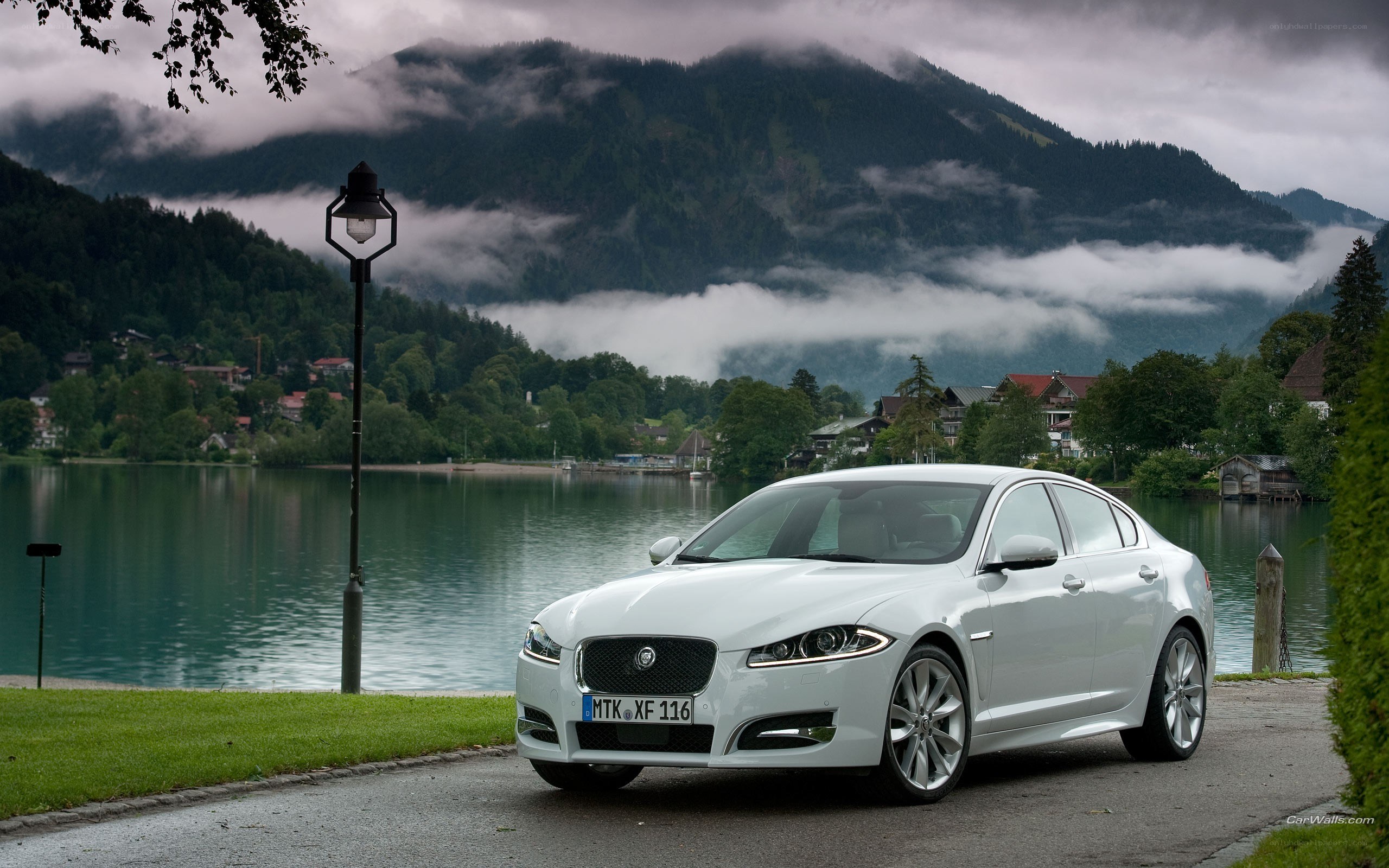 White Jaguar XFL by a lake