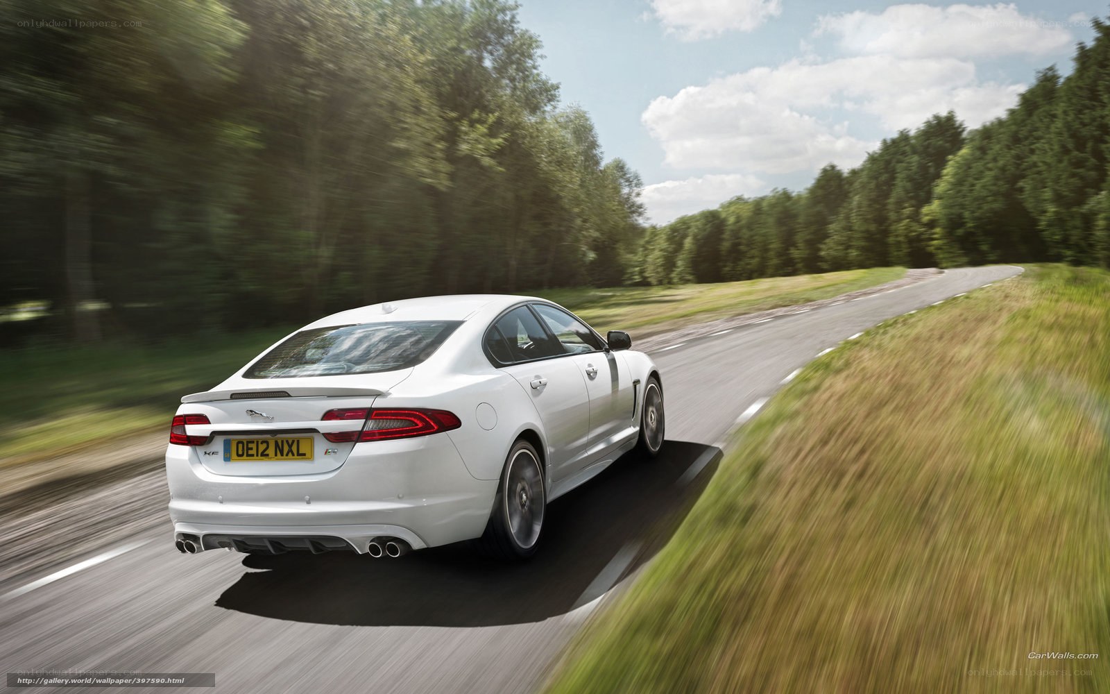 white jaguar xfr driving on road