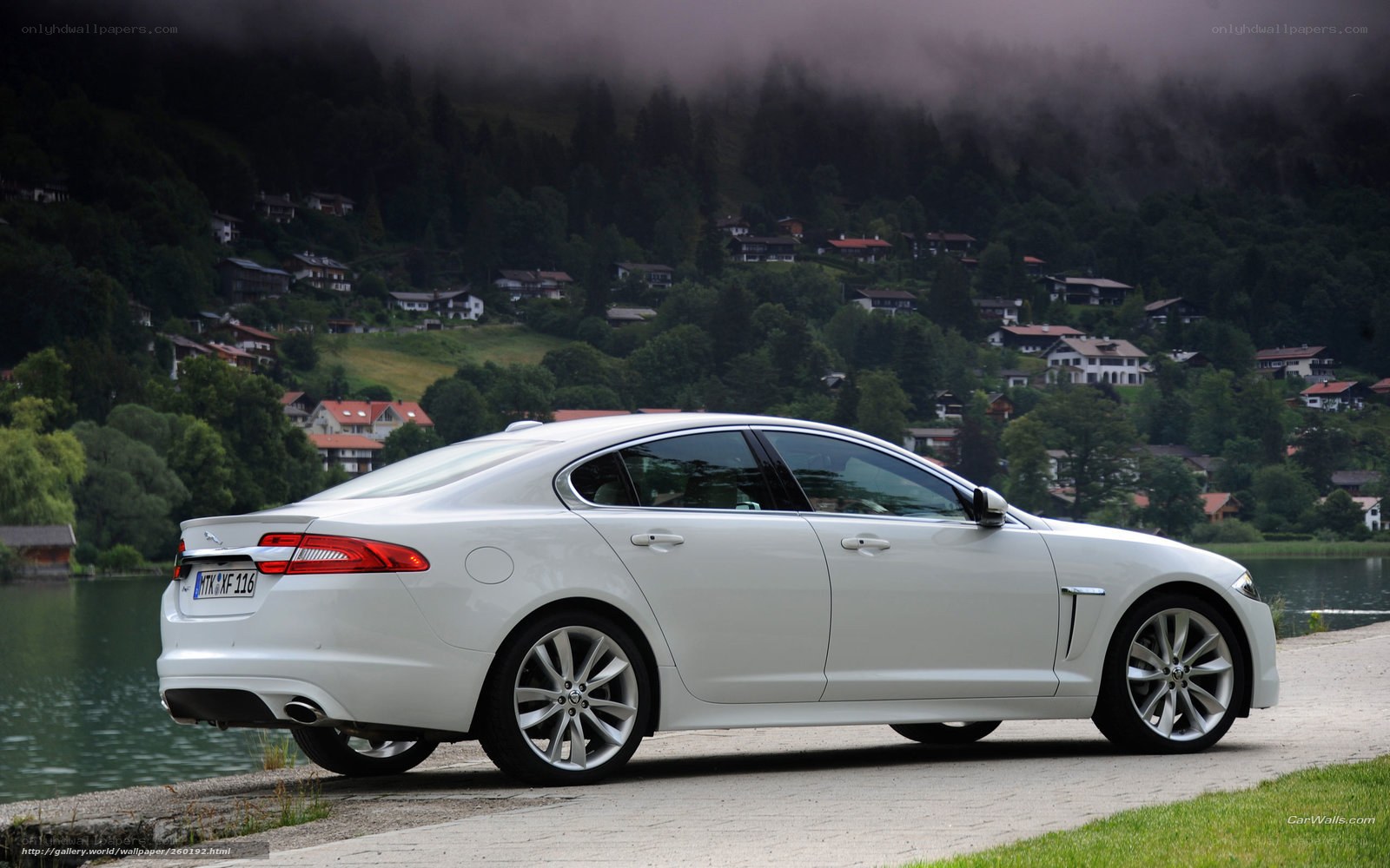 White Jaguar XJ by a lake