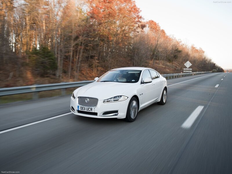 White Jaguar XJ driving on highway