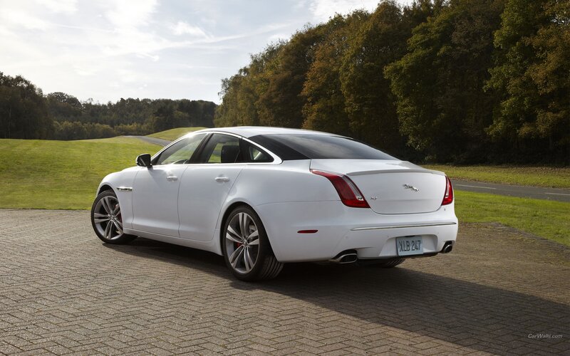 white jaguar xj parked on pavement