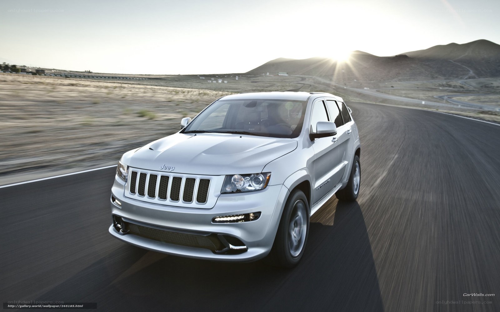 White Jeep driving on road