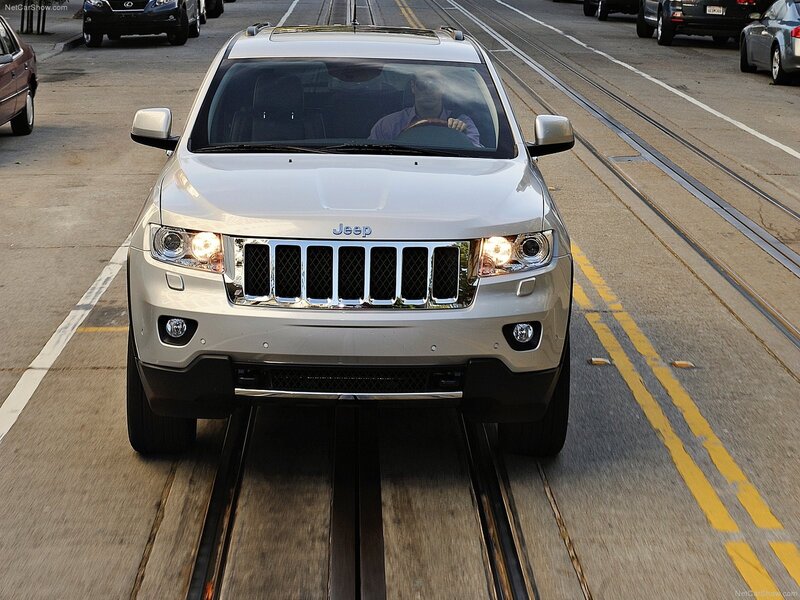 White Jeep on city street