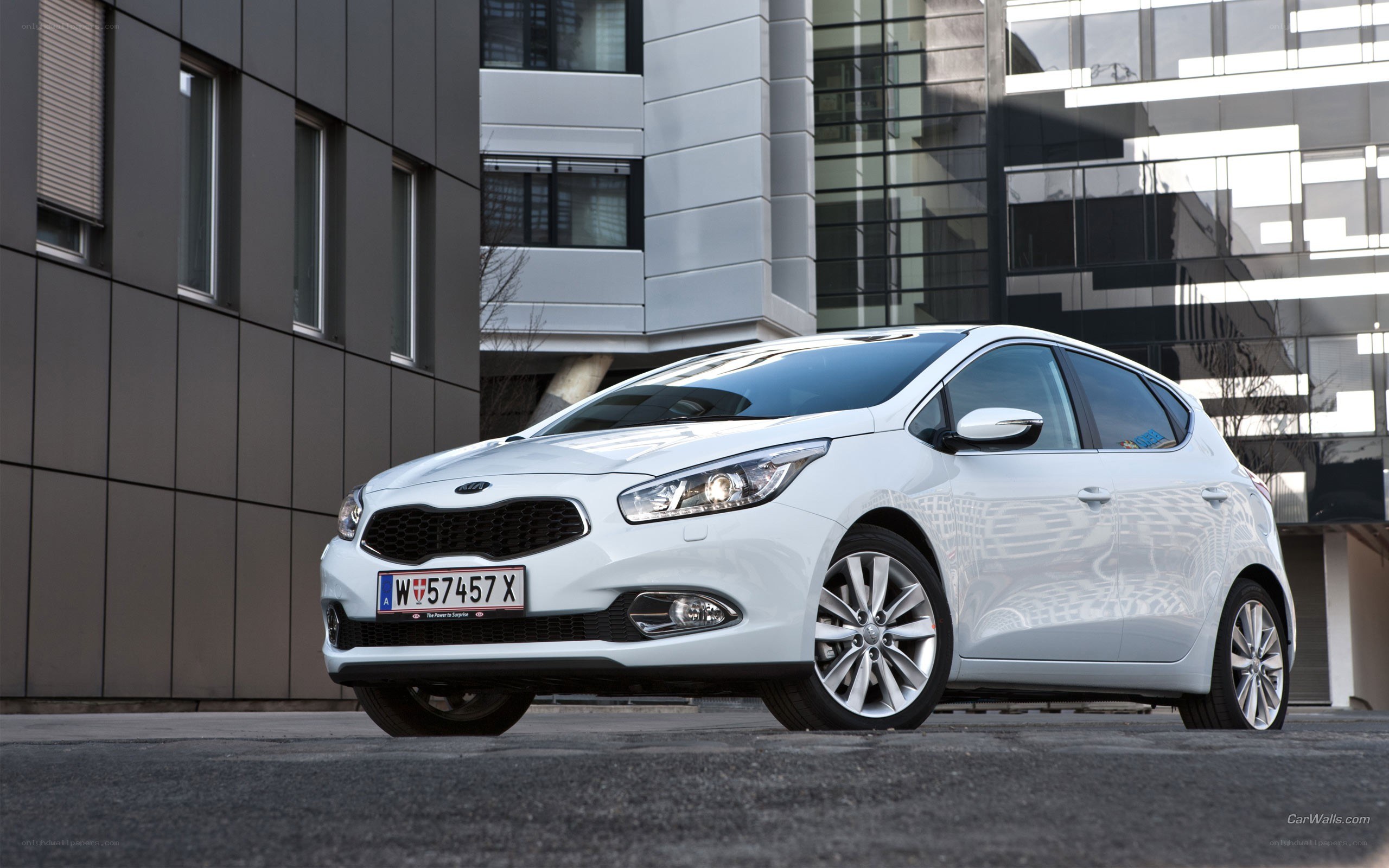 white kia cee'd parked outside