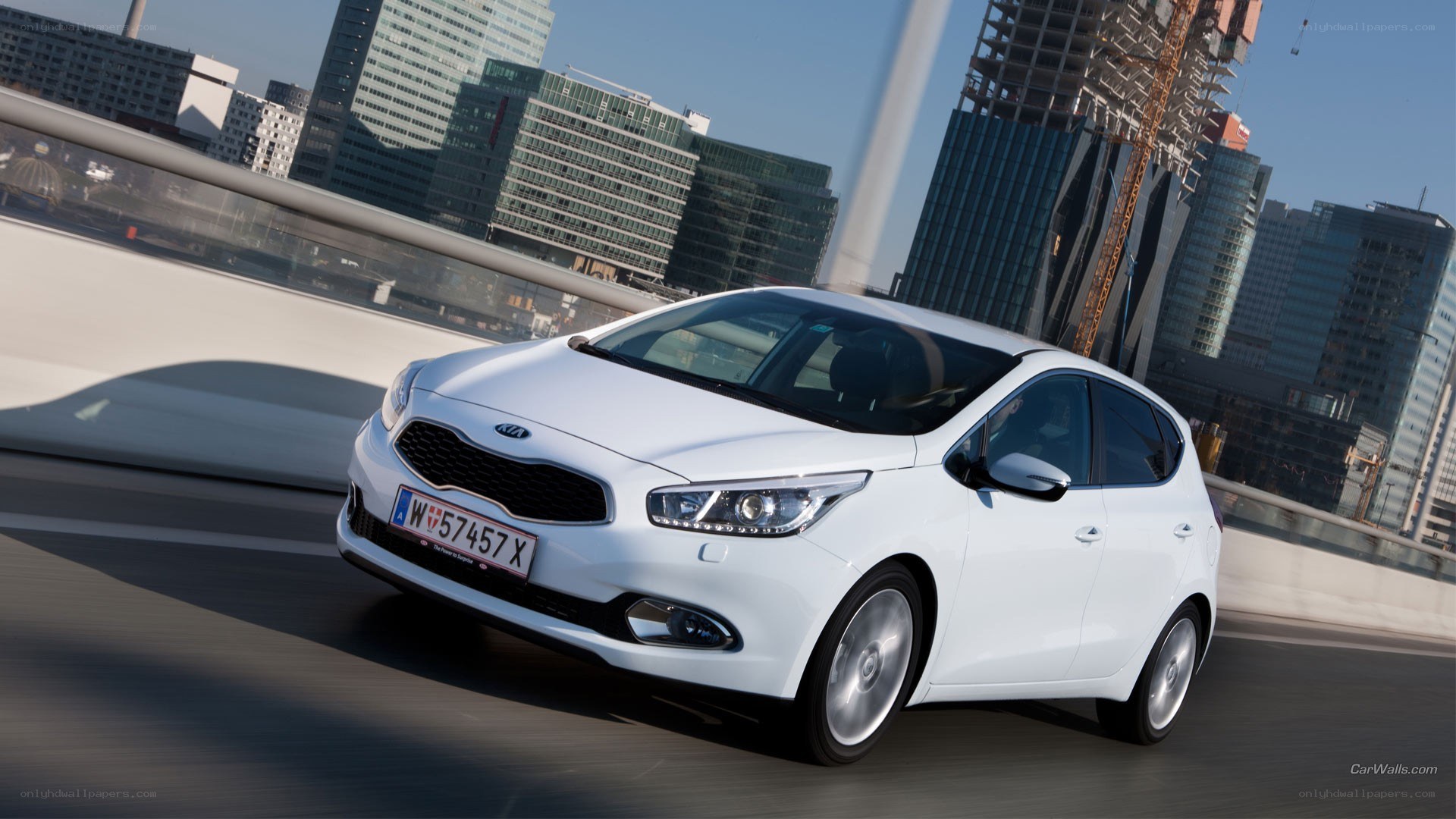White Kia Ceed driving in city