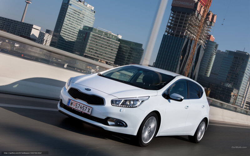 White Kia Ceed driving in city