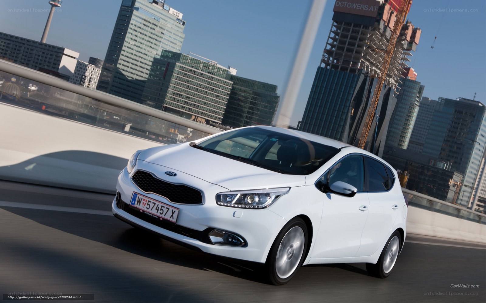 White Kia Ceed driving in city