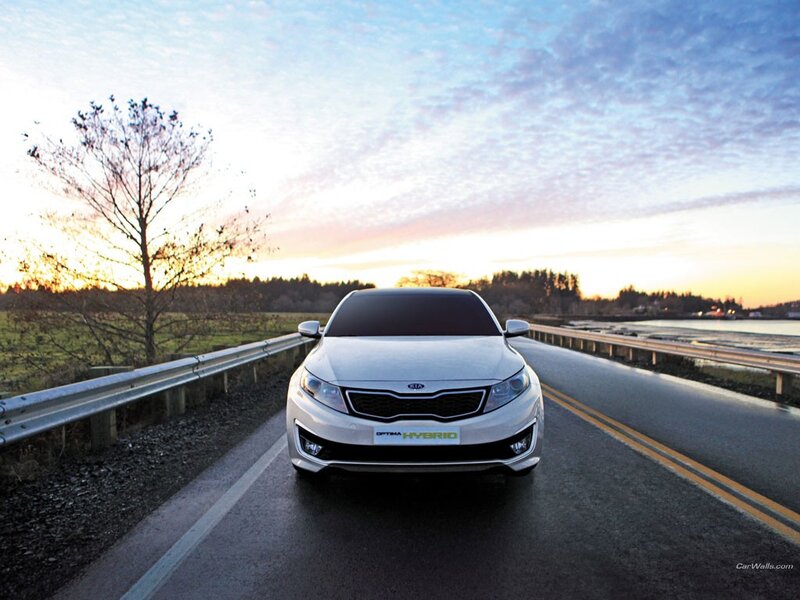 White Kia Optima Hybrid on a road