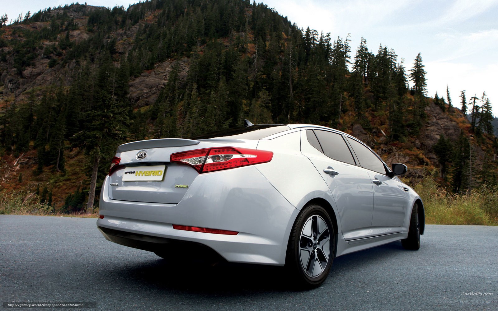 White Kia Optima Hybrid on mountain road