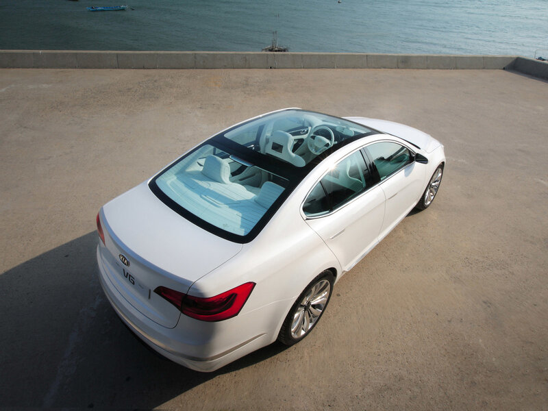 White Kia V6 sedan by the sea