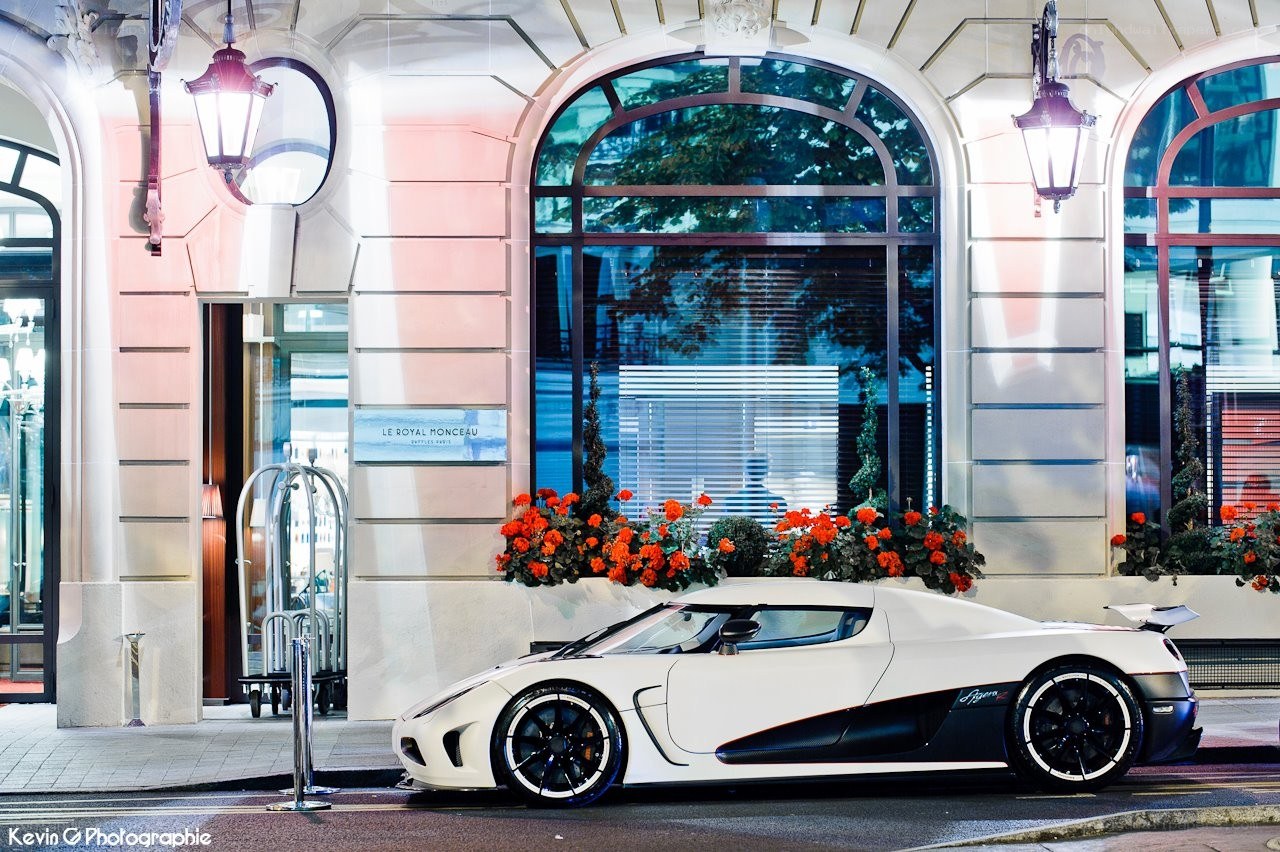 White Koenigsegg parked outside hotel