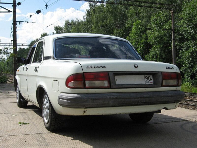 white lada car at railway crossing