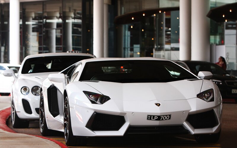 White Lamborghini and Bentley cars