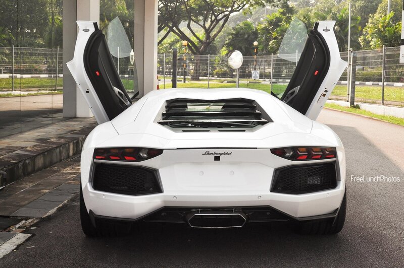 White Lamborghini Aventador with doors open