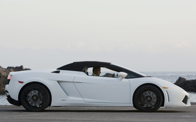 White Lamborghini convertible by the sea