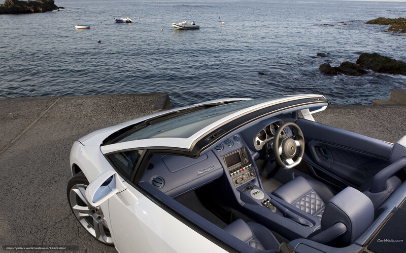 White Lamborghini convertible by the sea