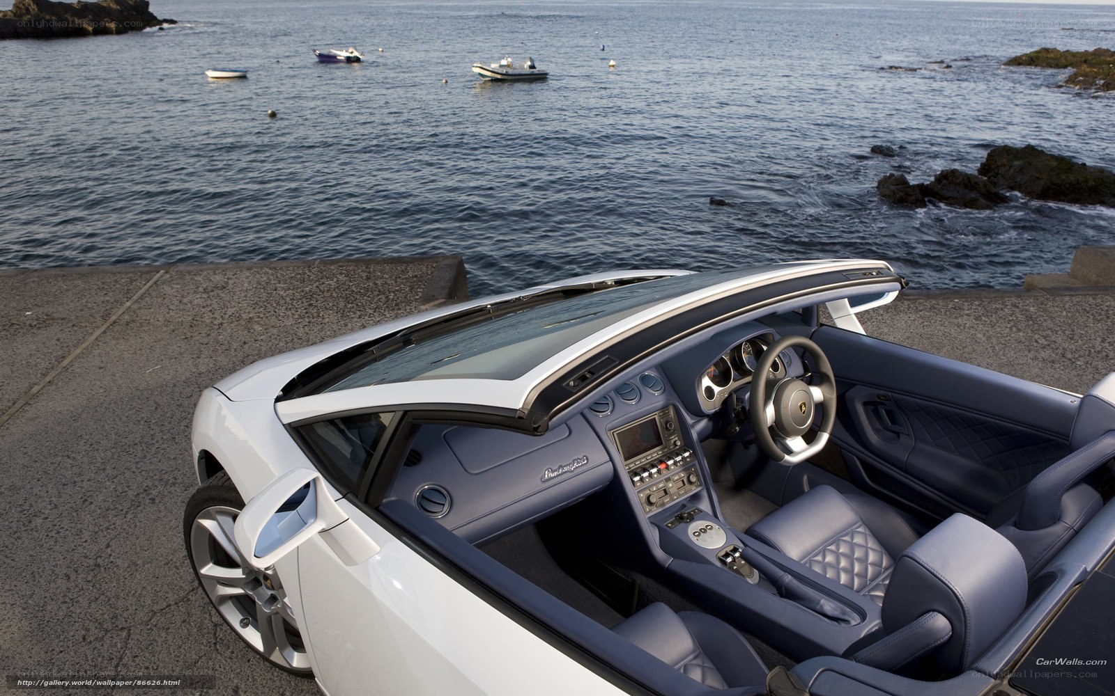 White Lamborghini convertible by the sea