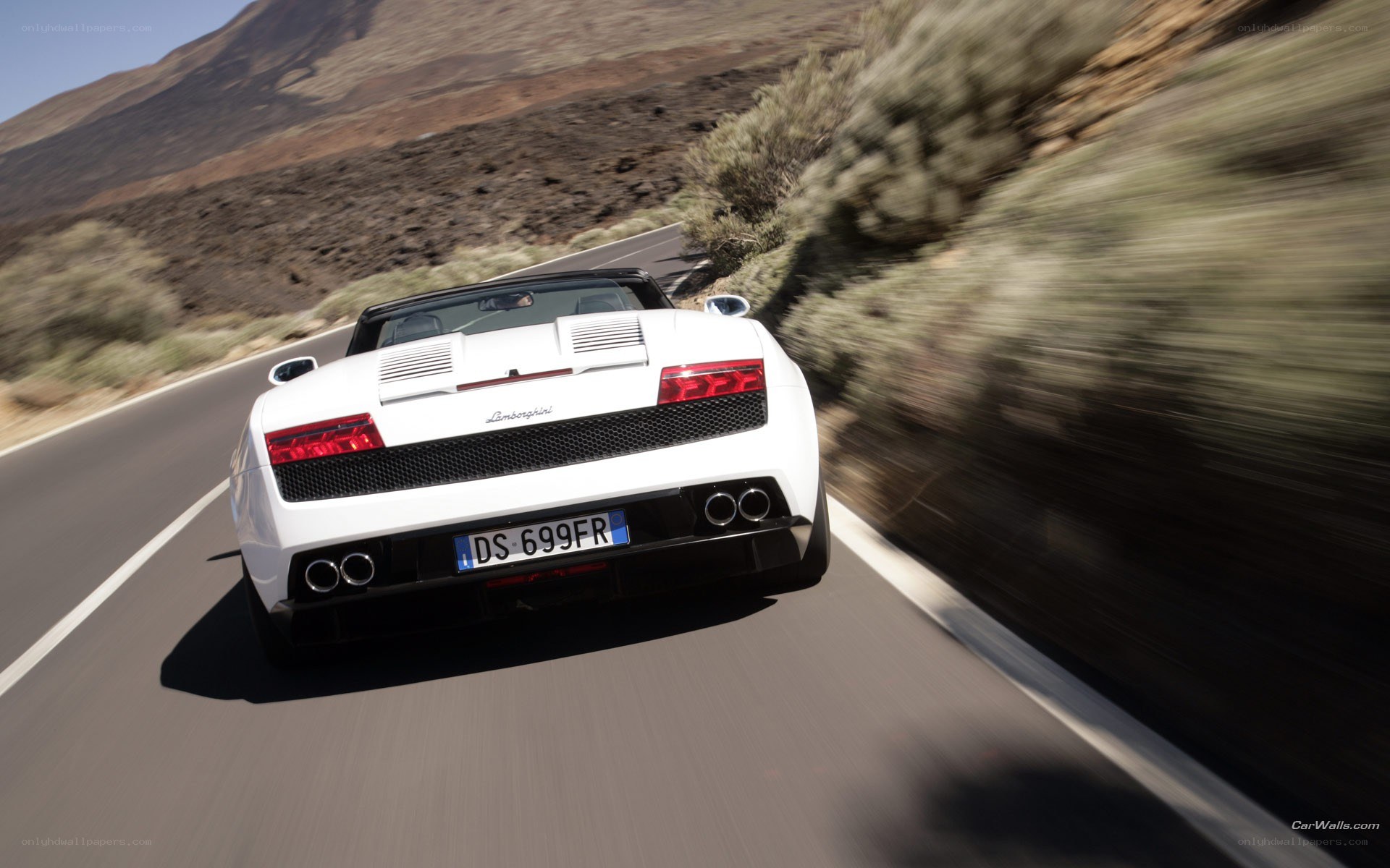 White Lamborghini driving on road