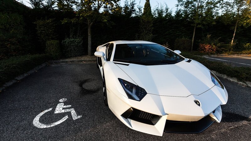 White Lamborghini in disabled parking spot