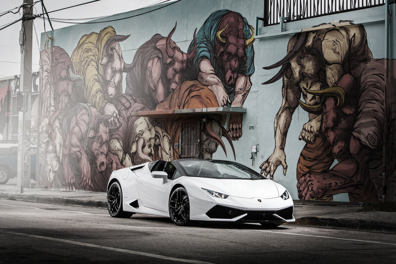 White Lamborghini in front of mural