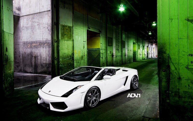 White Lamborghini in green-lit garage