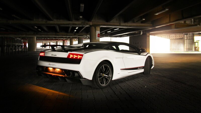 white lamborghini in parking garage