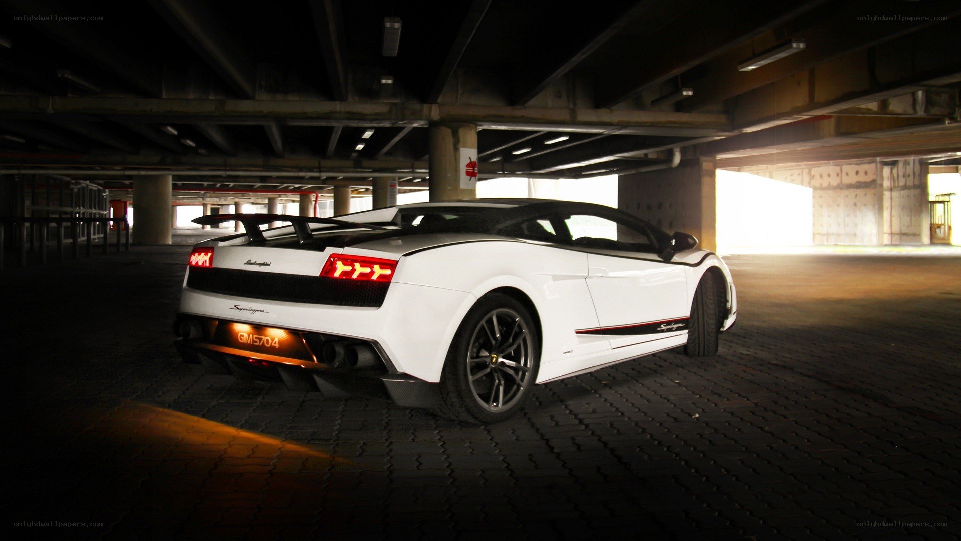 white lamborghini in parking garage