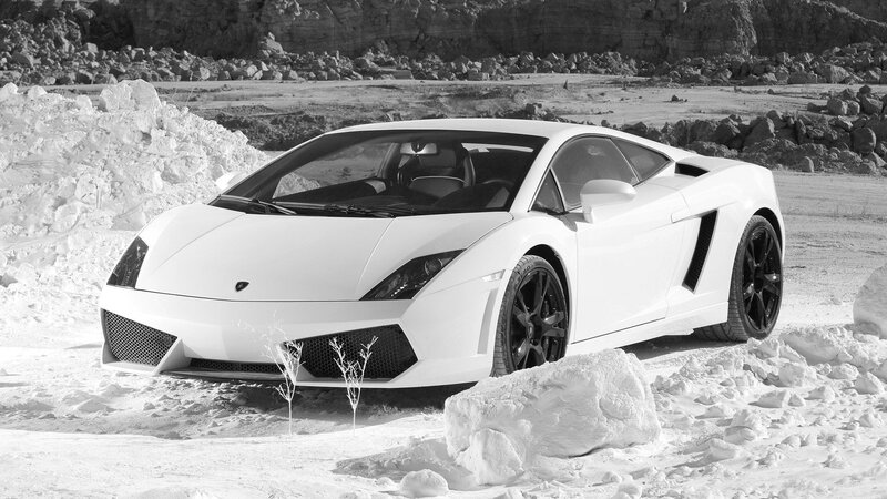 White Lamborghini in Snow — Dramatic, Photograph, Rocks