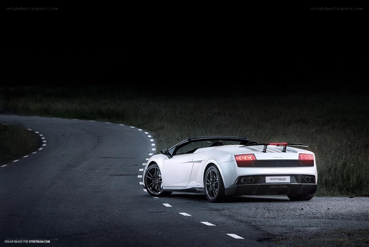 White Lamborghini on a dark road