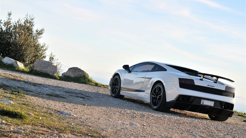 White Lamborghini on a gravel road