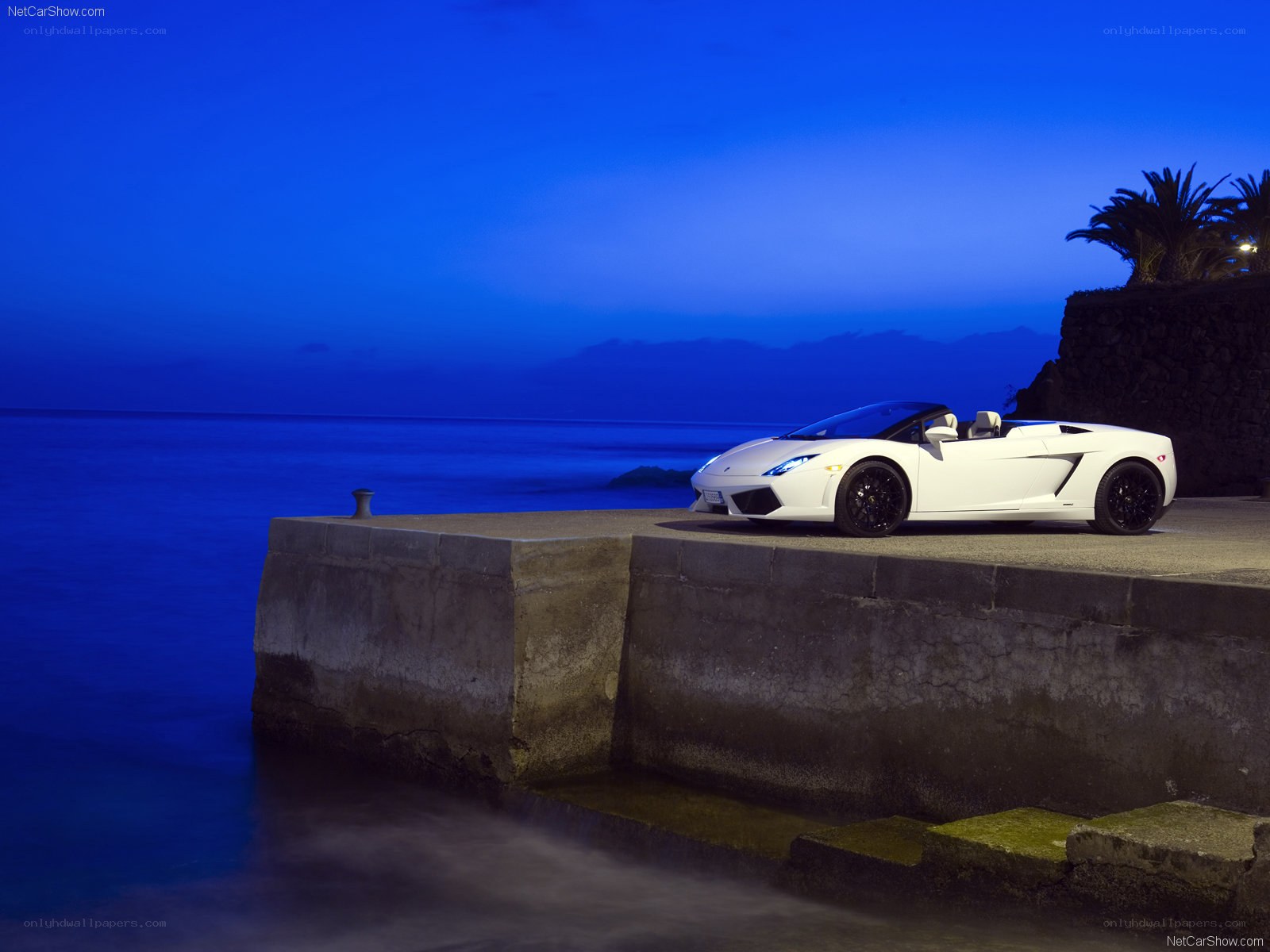 White Lamborghini on a pier at dusk