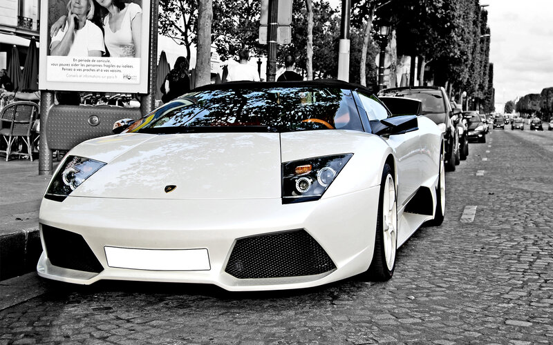 White Lamborghini on cobblestone street