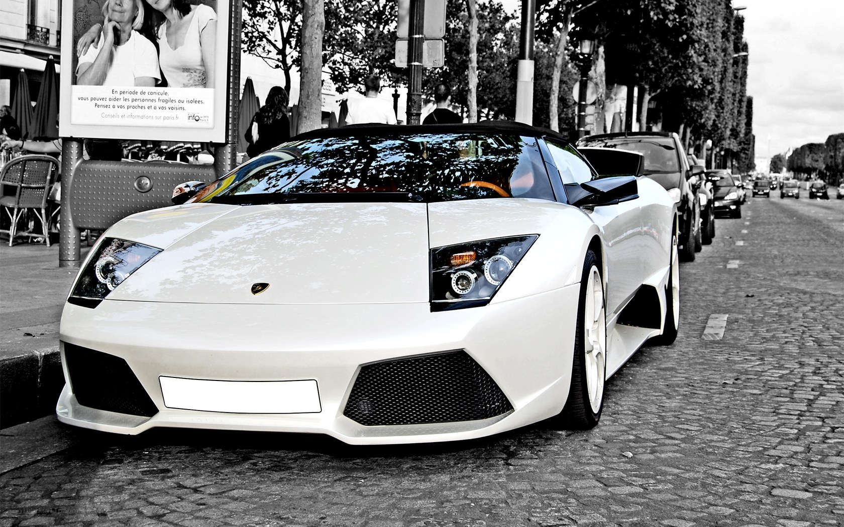 White Lamborghini on cobblestone street