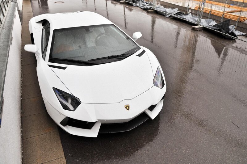 White Lamborghini on wet pavement