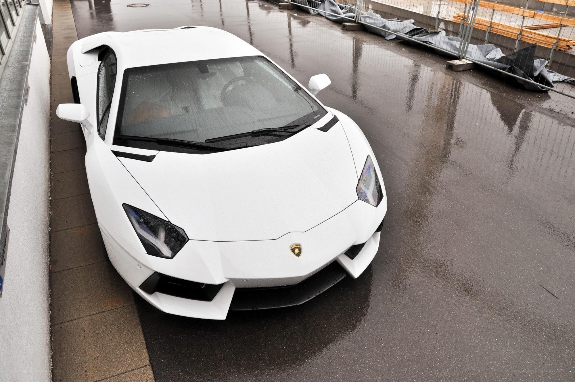 White Lamborghini on wet pavement