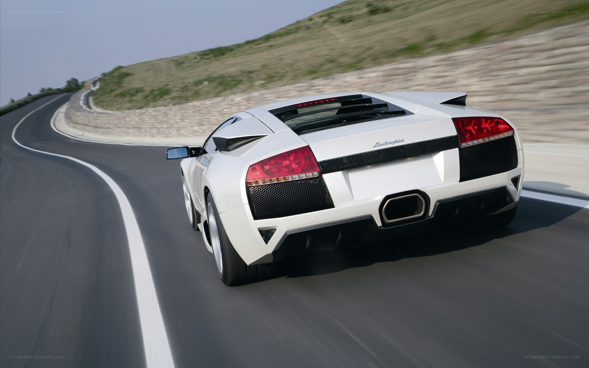 white lamborghini on winding road