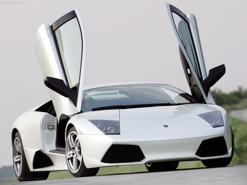 white lamborghini with doors open
