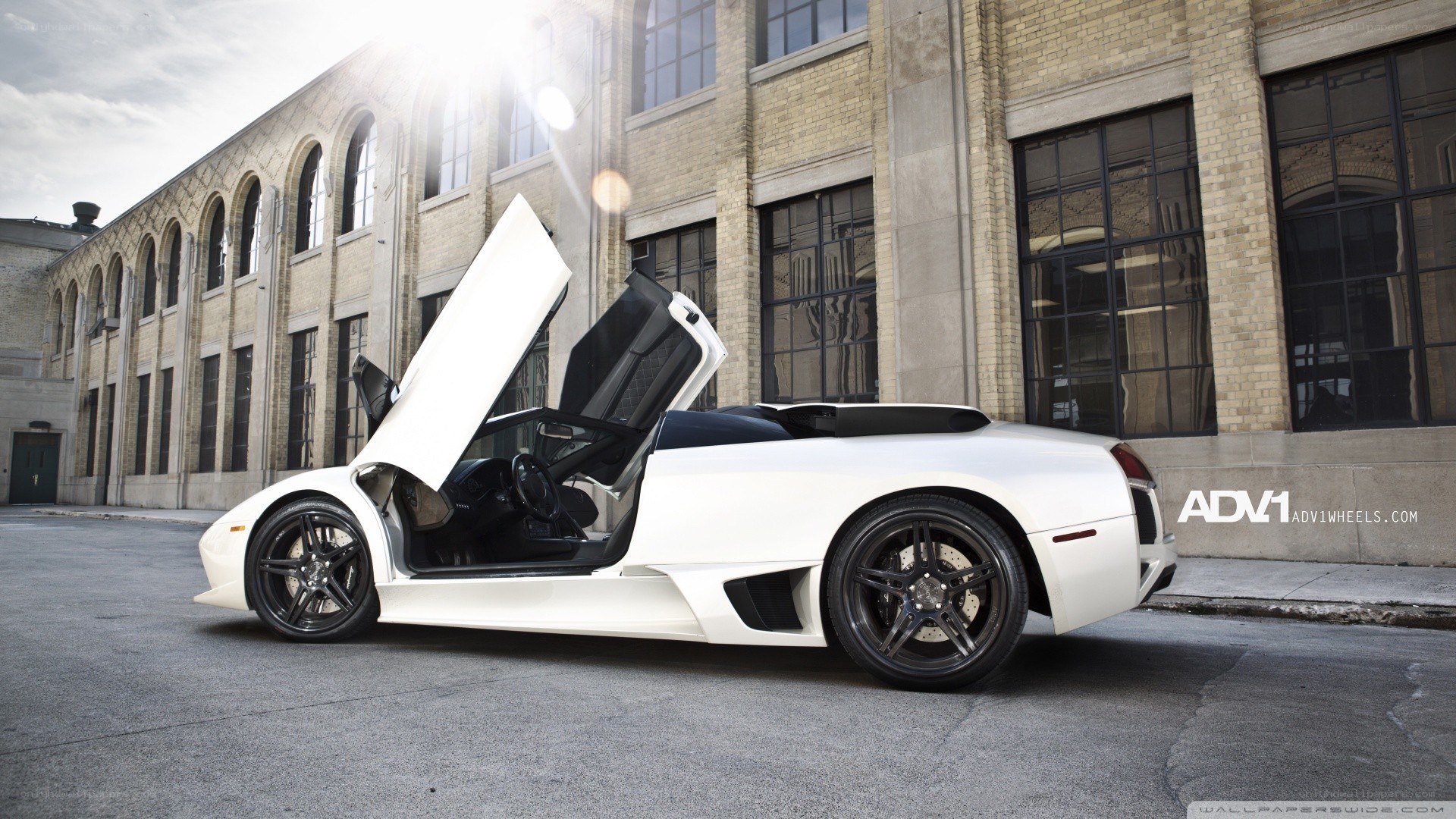 white lamborghini with open doors