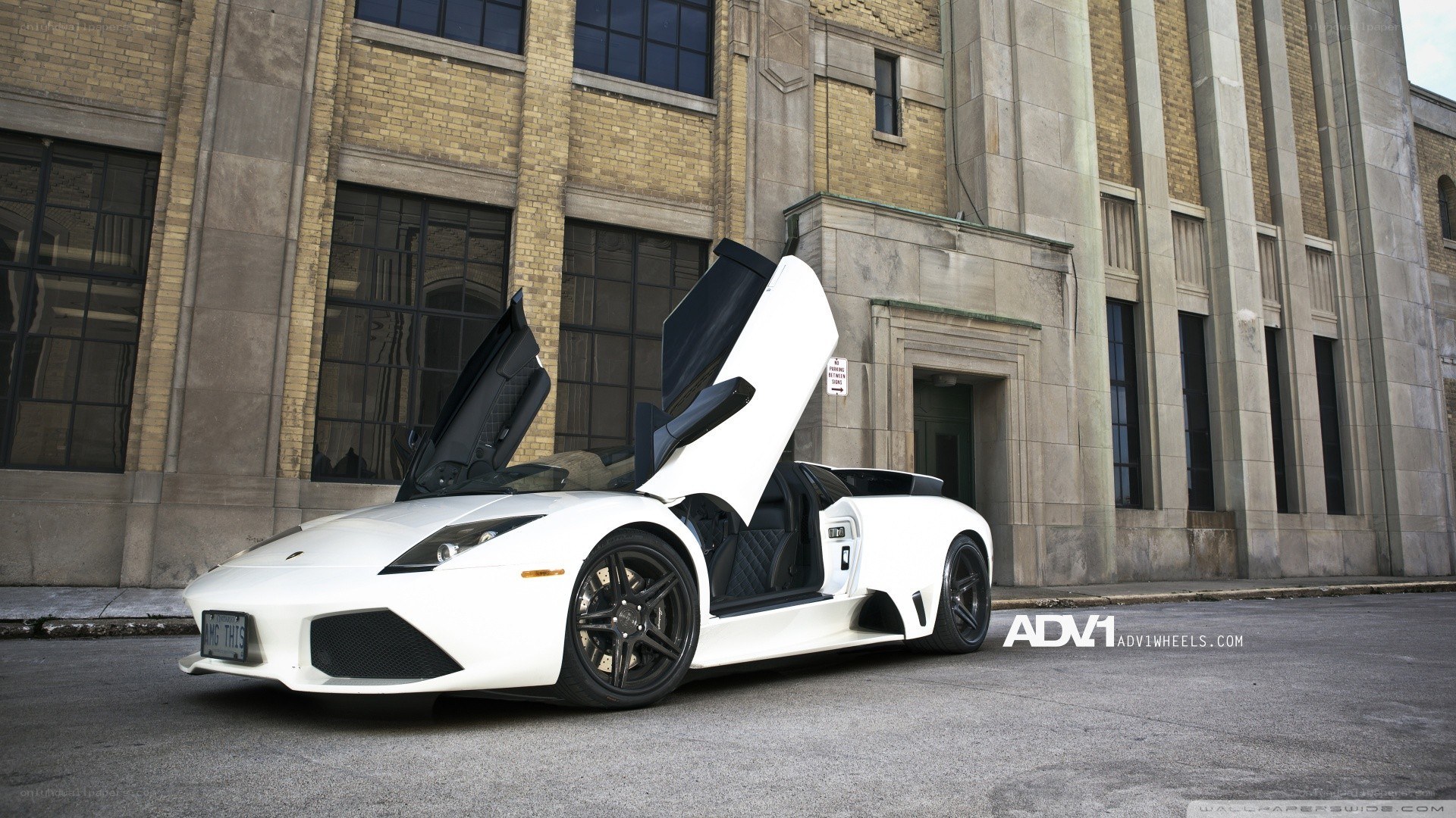 white lamborghini with open doors