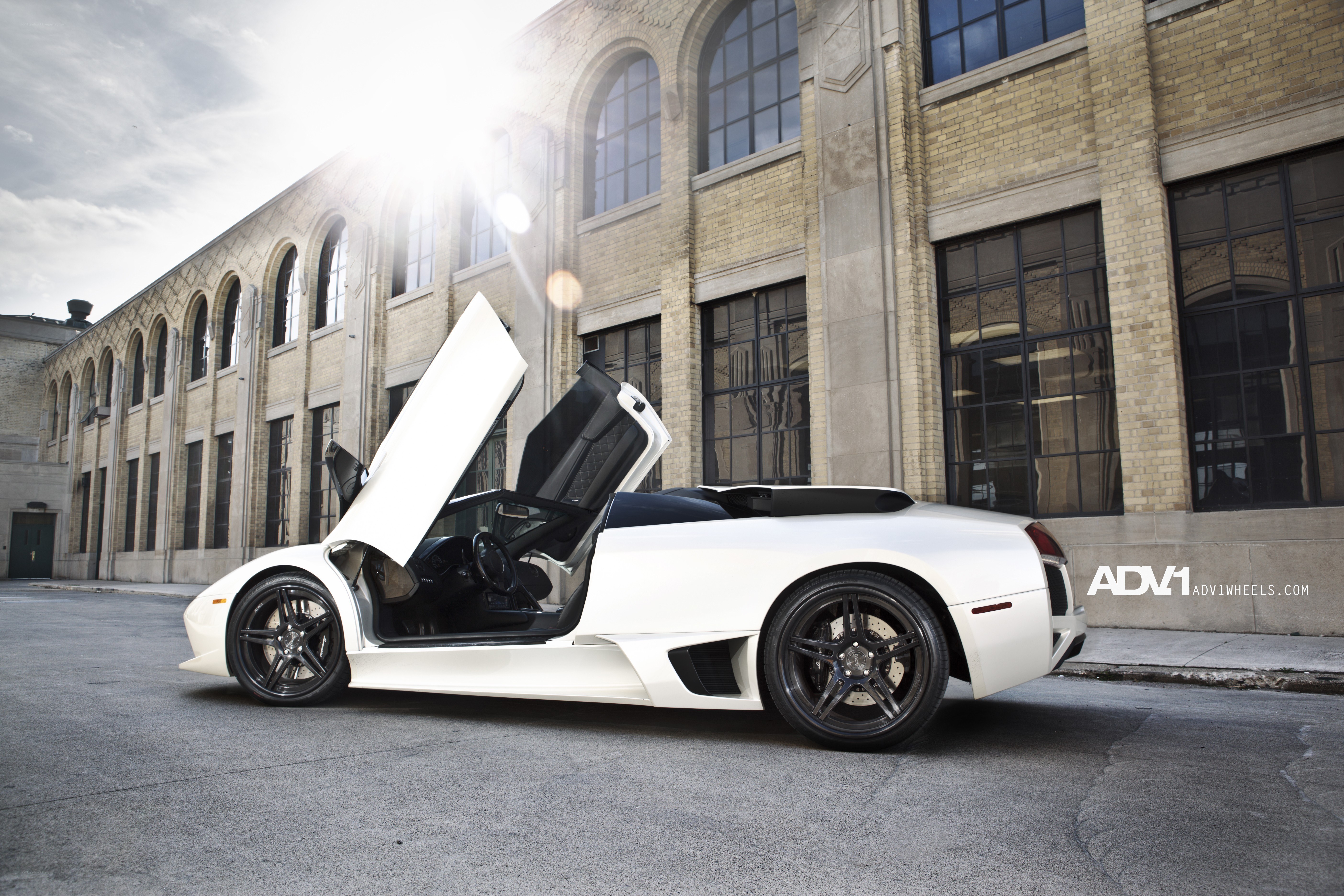white lamborghini with open doors