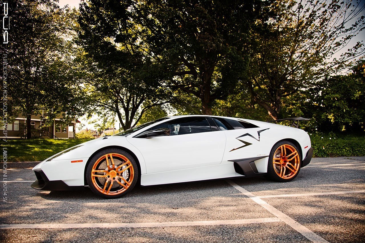 white lamborghini with orange wheels